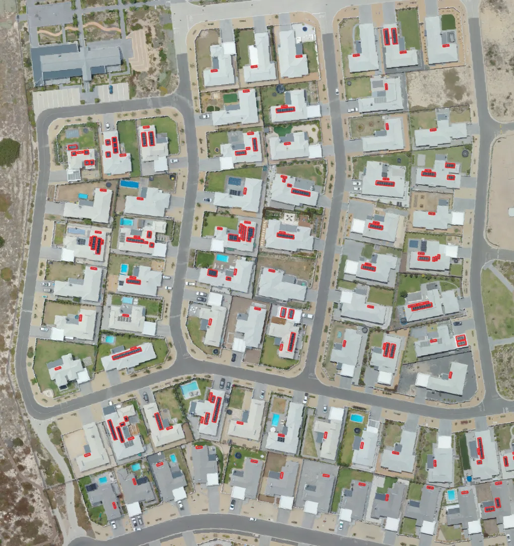 Suburb-level solar panel detection — red boxes mark detected rooftop panels across a residential area
